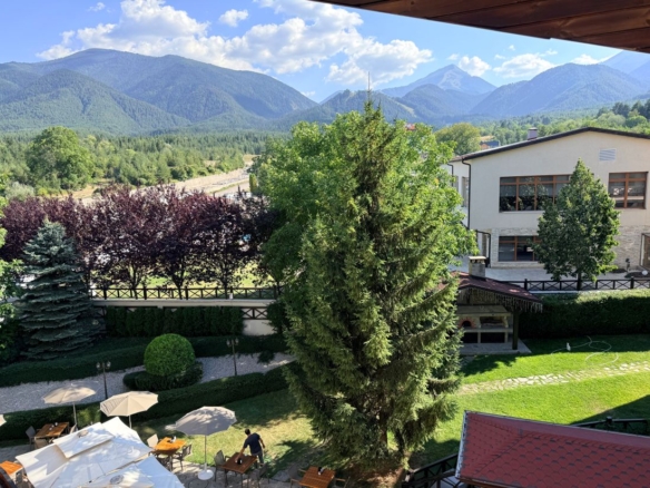 Regnum Bansko apartment terrace view over the garden to the Pirin mountains