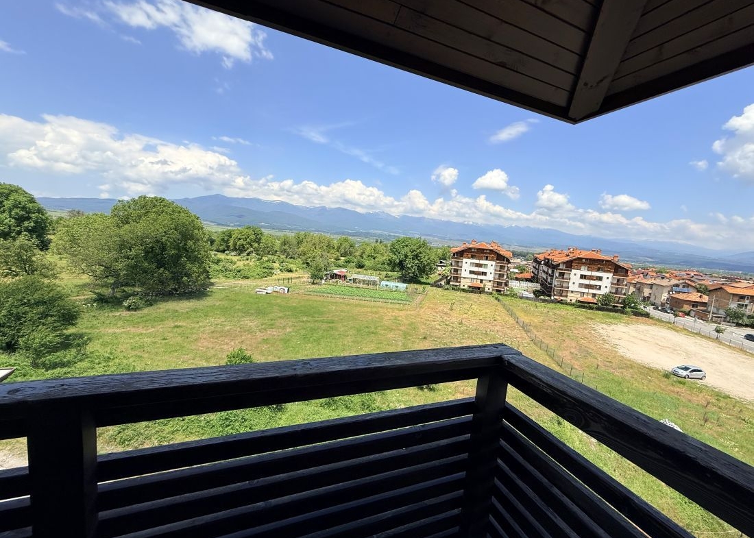 Alpine Lodge Bansko apartment bedroom with double bed and wardrobe