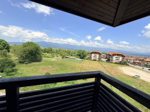 Alpine Lodge Bansko apartment bedroom with double bed and wardrobe