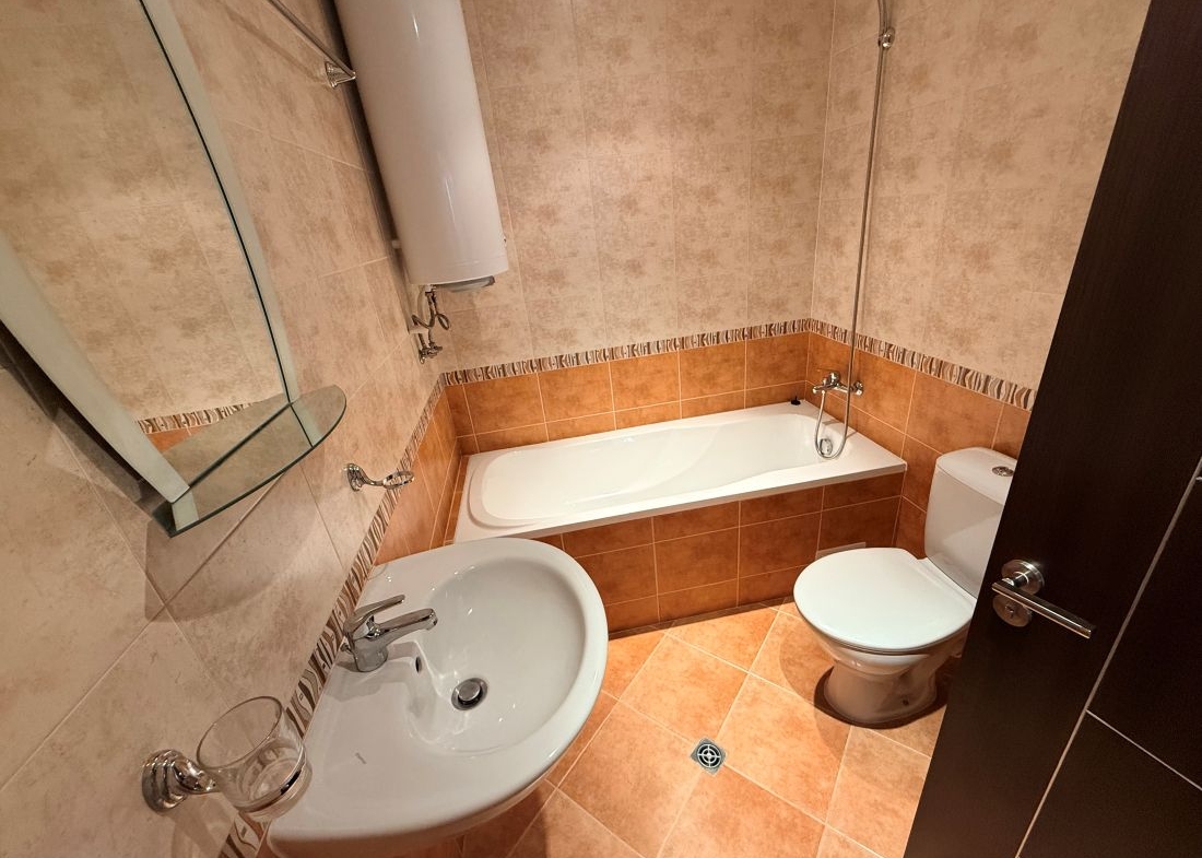 Alpine Lodge Bansko apartment bedroom with double bed and wardrobe