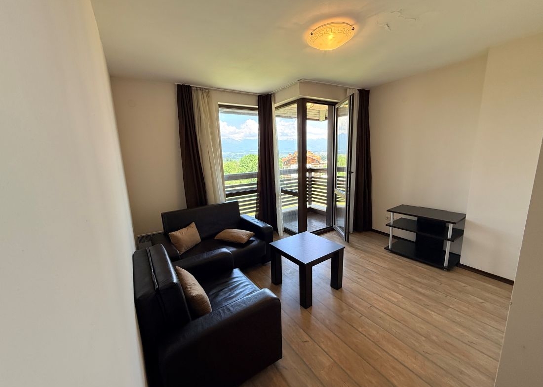 Alpine Lodge Bansko apartment bedroom with double bed and wardrobe