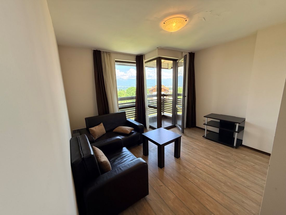 Alpine Lodge Bansko apartment bedroom with double bed and wardrobe