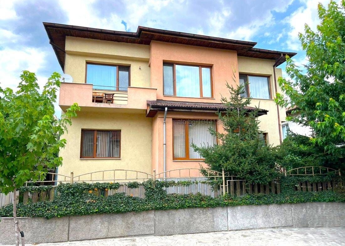 Rear of the two-storey house in Razlog with balcony and garden path