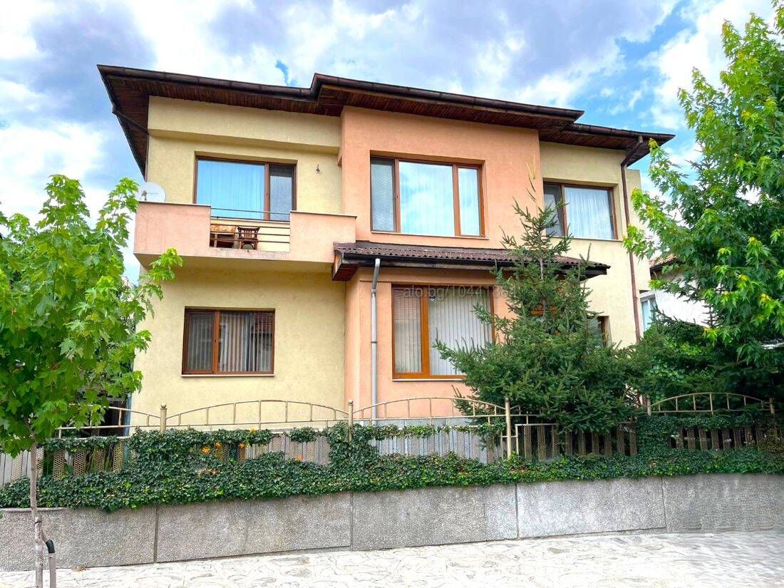 Rear of the two-storey house in Razlog with balcony and garden path